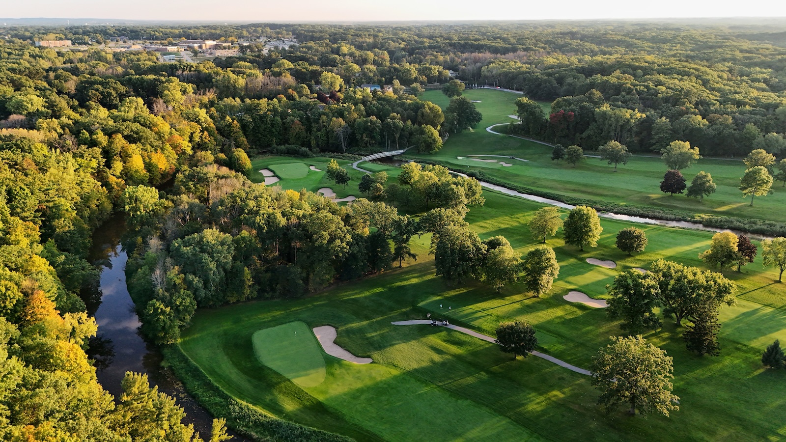 The Best Guide to Visiting Blackwolf Run Golf Course 1 Blackwolf Run Golf Course is a panoramic view of rolling greens, trees, and a river.
