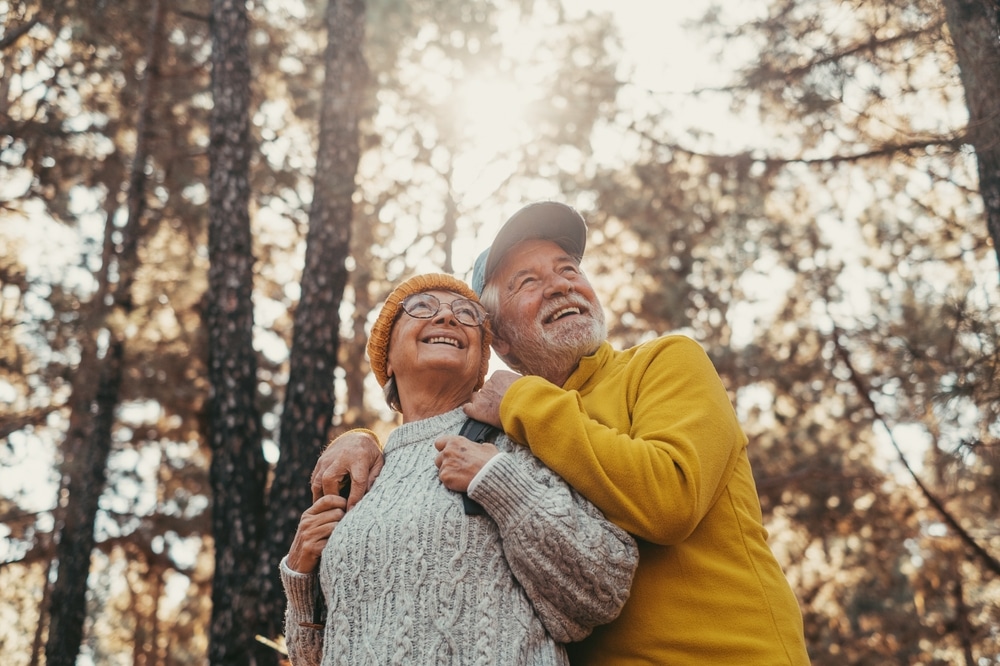 A senior couple outside in the woods enjoying one of the most romantic getaways in Wisconsin