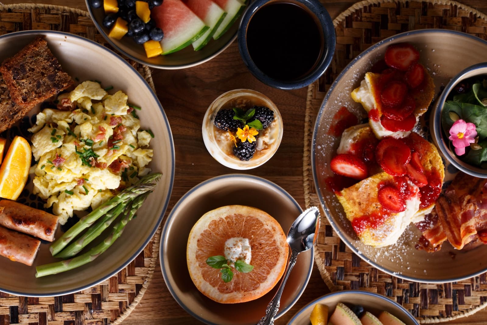 Grab Your Bike and Ride the Lake to Lake Trail 2 At the best Bed and Breakfast Wisconsin, you'll find a spread of breakfast on a wood table featuring a yogurt parfait, eggs, french toast, and a grapefruit.